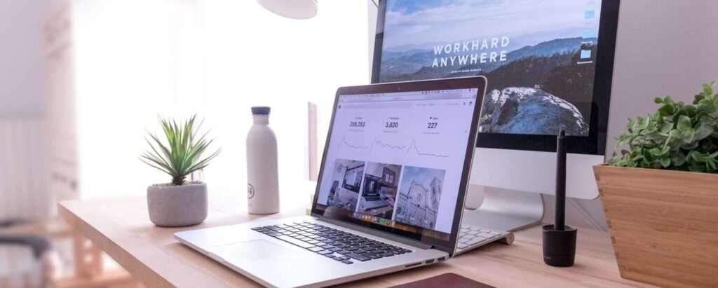 a laptop and PC on a desk