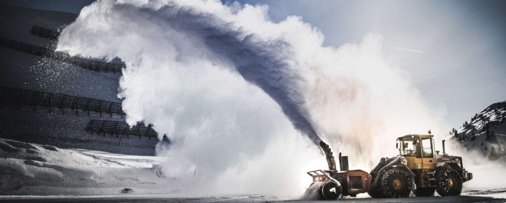 snow plowing machine cleaning snow