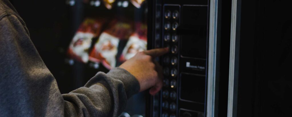 a person choosing a product from a Vending Machine 