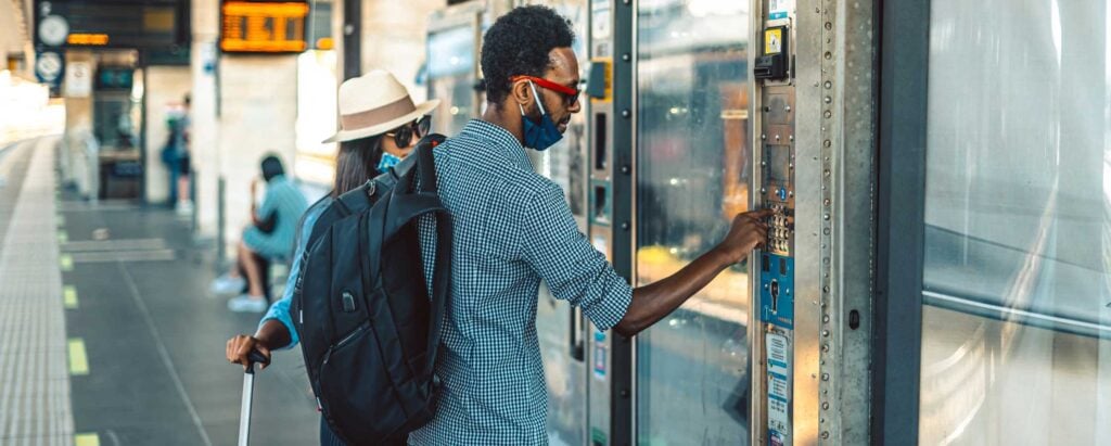 a man choosing a product from a vending machine