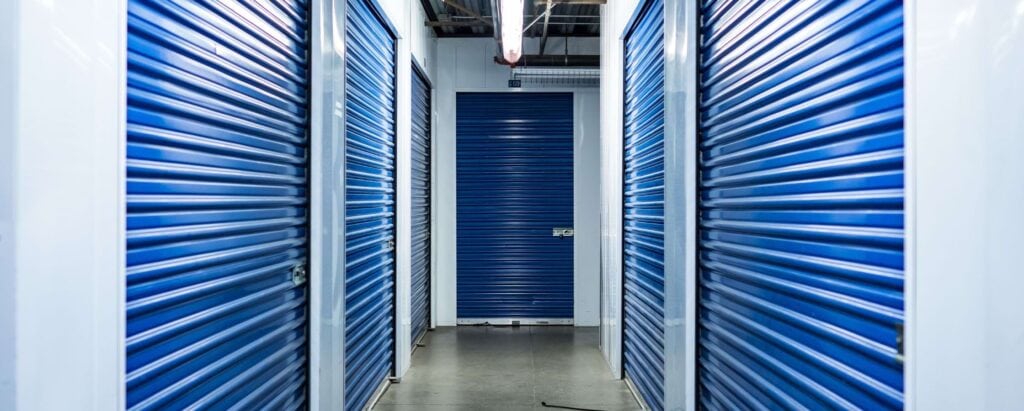 a halway with storage units with bluedoors