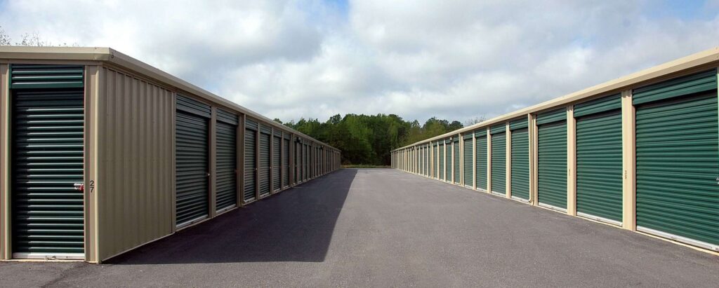 a view rows of storage units with green doors