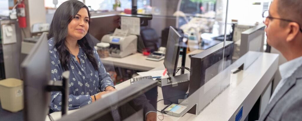 a bank teller serving a customer