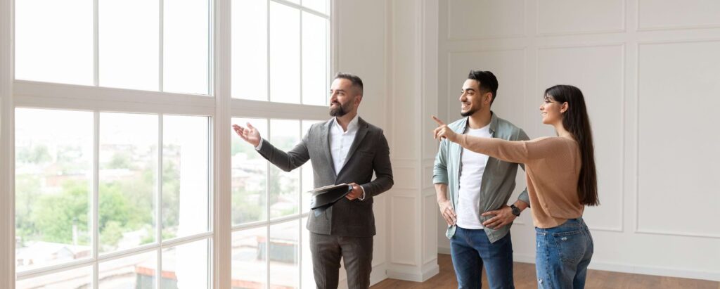 a real estate agent showing a house to a couple