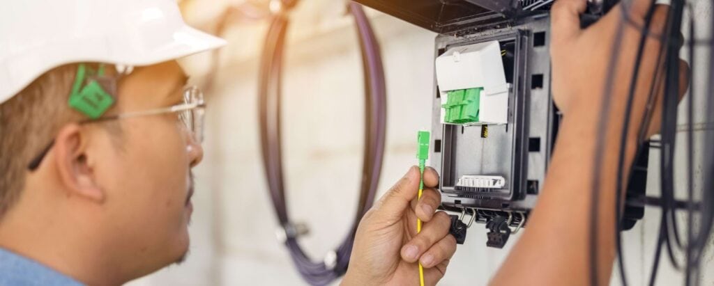 a telecommunications worker connecting cables