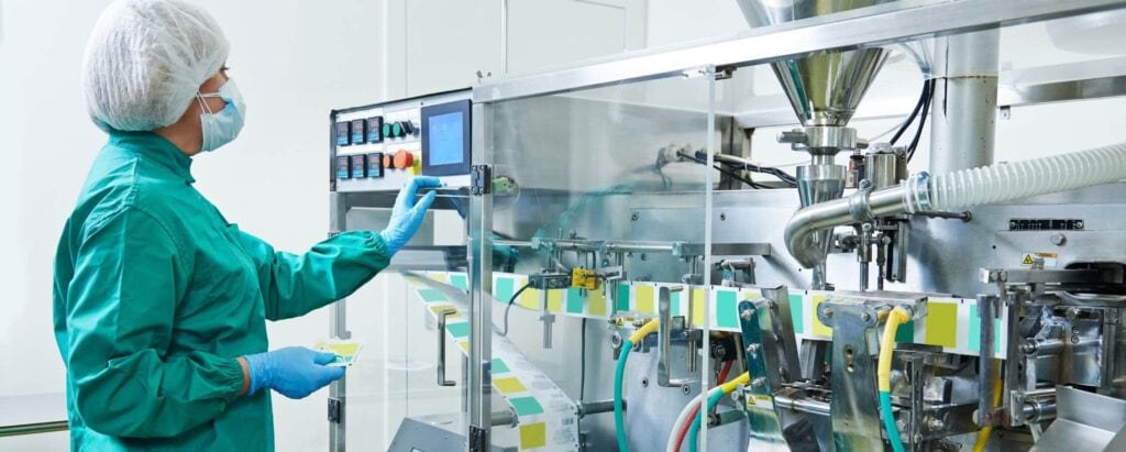 a pharmaceutical worker controlling a production line