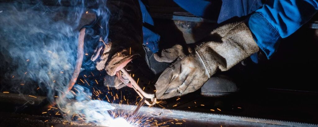 a person with gloves welding metal