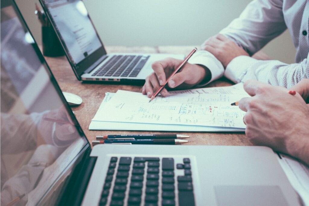 two workers in the building products industry reviewing documents