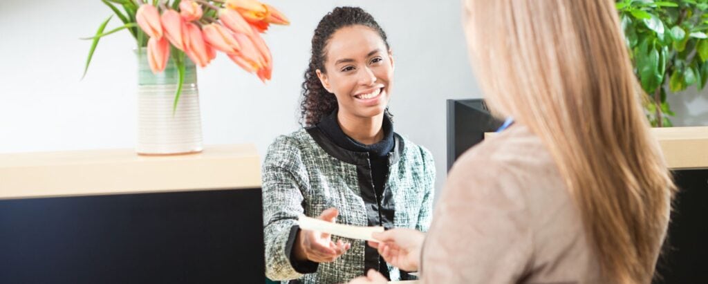 A person cashes a check in a bank