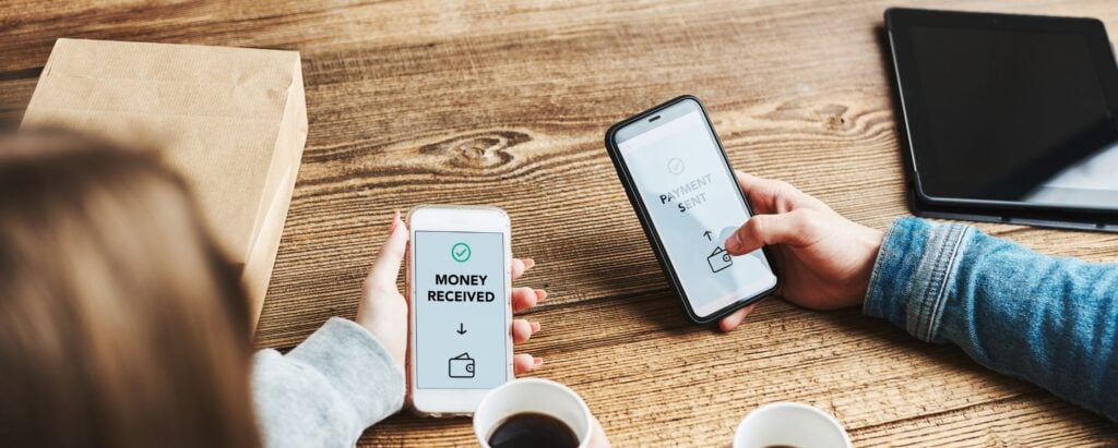 A person sending money to another person via mobile app